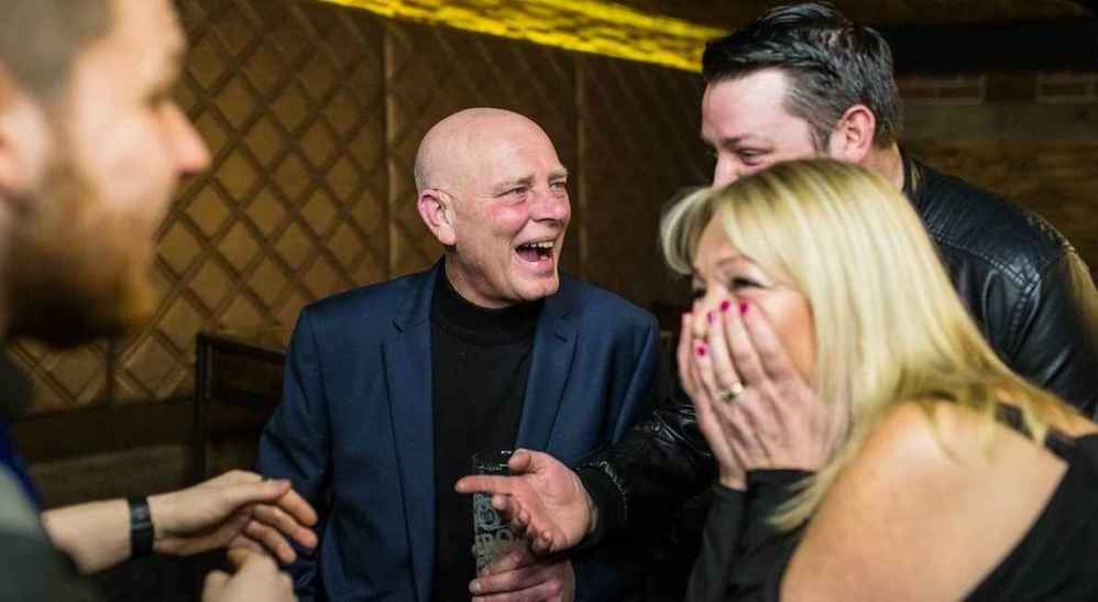 Close-up magician entertaining VIPs during a networking drinks reception