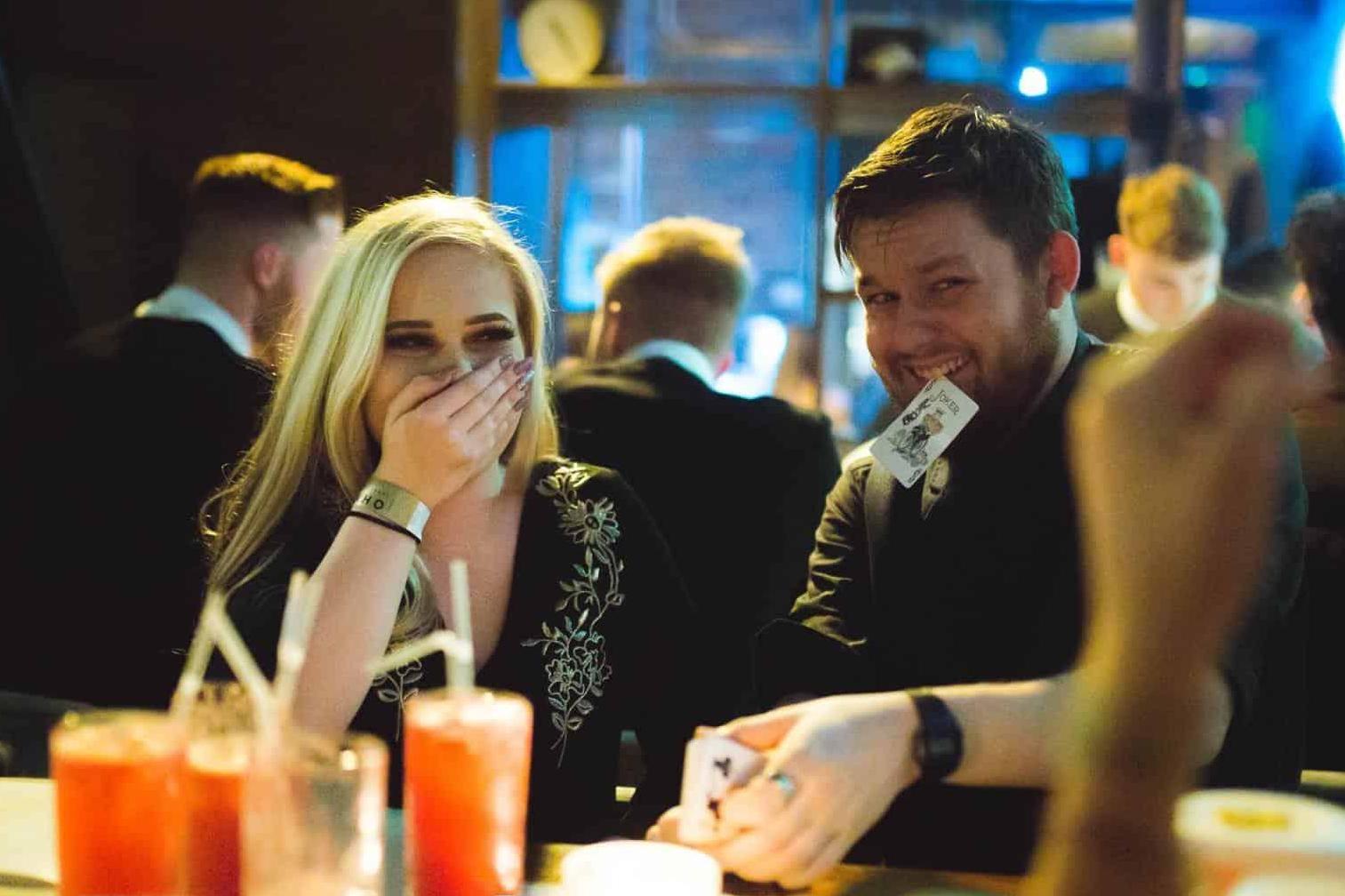 Magician Greg Holroyd stuns guests at OHM Sheffield with a jaw-dropping card reveal—audience reactions full of laughter and disbelief