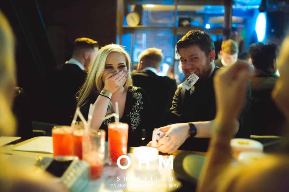 Close-up magician performing for guests at a corporate hospitality event