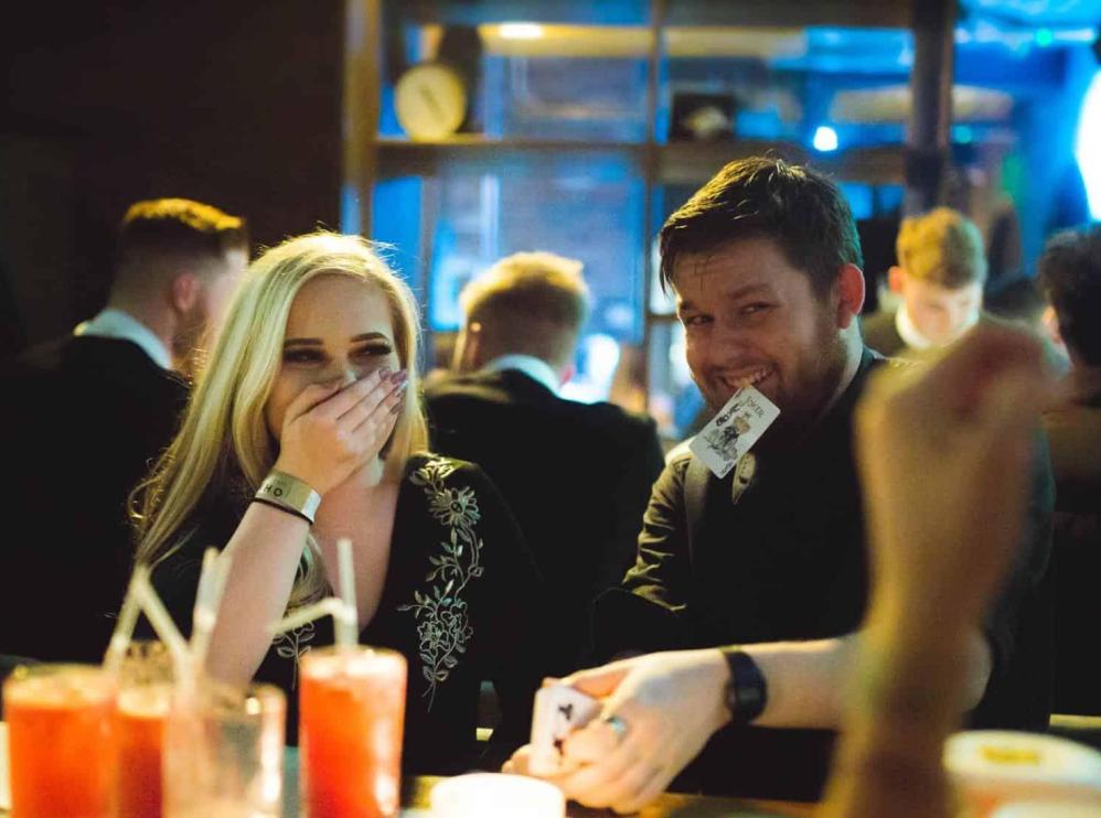 Close-up magician performing for guests at a corporate hospitality event