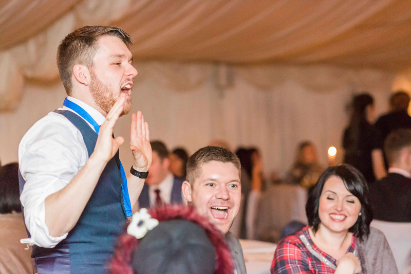 Greg Holroyd stuns guests during a magic performance, sparking laughter and amazement around the table.